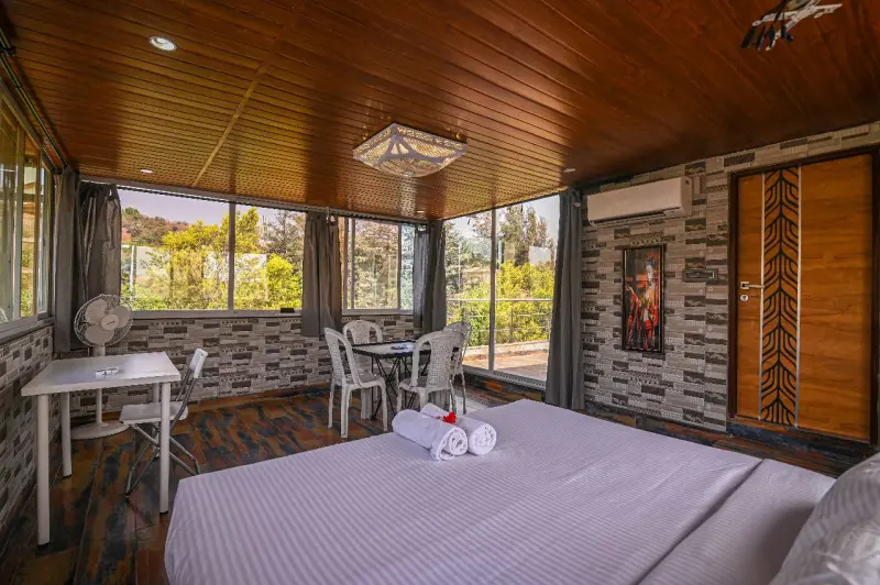 Cozy villa Cirrus bedroom with full window coverage and modern setup Misty Palace Villa, Lonavala