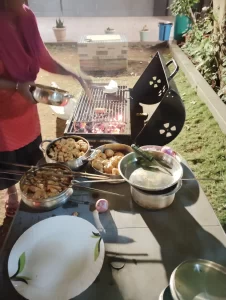 Guest enjoying a barbecue at Misty Palace Villa Lonavala under open skies