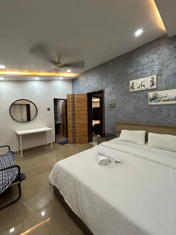 Sophisticated villa Cumulus bedroom with scenic artwork and warm tones - Misty Palace Villa, Lonavala