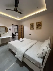 Luxurious Services Modern Amenities 7 Modern Stratus bedroom with soft lighting and round mirror setup - Misty Palace Villa, Lonavala