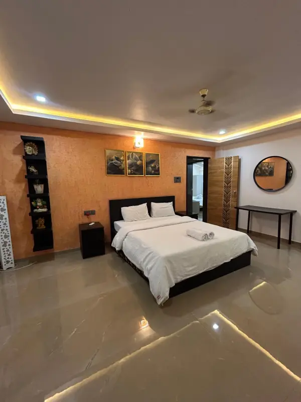 Nimbus bedroom with warm lighting, art decor, and modern furniture - Misty Palace Villa, Lonavala