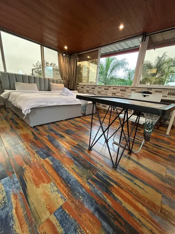 Colorful Cirrus bedroom flooring with scenic outdoor view - Misty Palace Villa, Lonavala