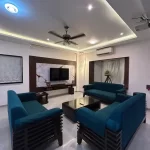 Contemporary living room with teal sofas and modern decor -