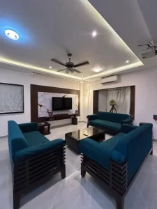 Contemporary living room with teal sofas and modern decor -