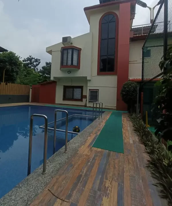 Luxury pool view with villa architecture in the backdrop - Misty Palace Villa, Lonavala