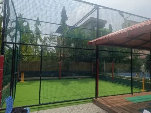 Shaded cricket turf with net enclosure and seating area - Misty Palace Villa, Lonavala