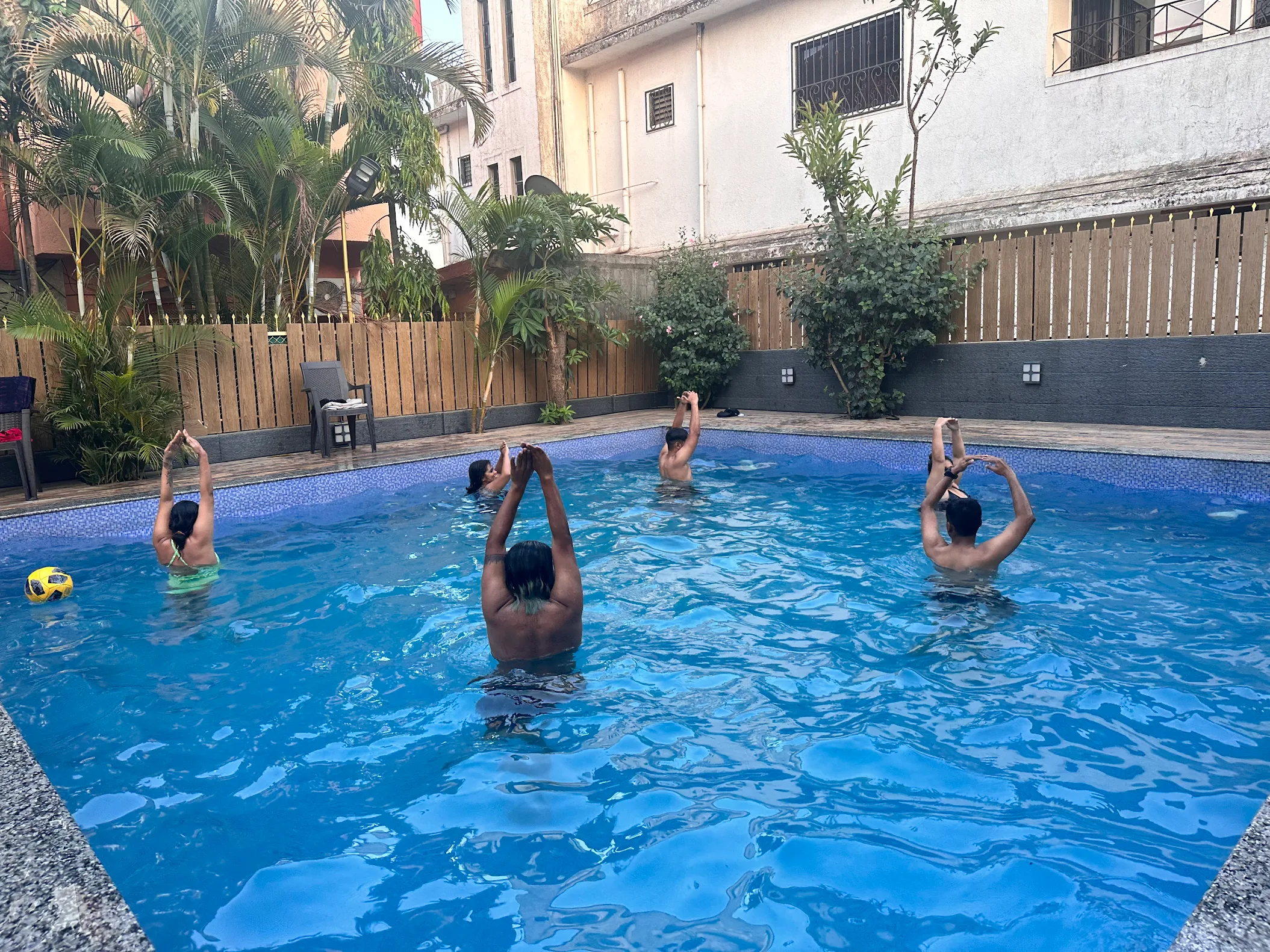 Guests performing yoga exercises in the pool at Misty Palace Villa Lonavala