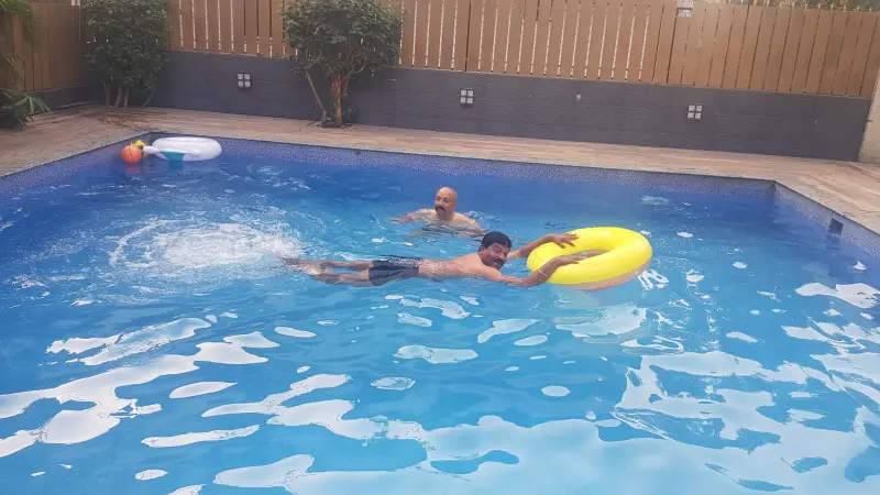 Top 8 Fantastic Monsoon Experiences in Lonavala for Group Travelers 11 Private swimming pool at Misty Palace 5 BHK luxury villa in Lonavala with guests enjoying a fun swim monsoon experiences in Lonavala